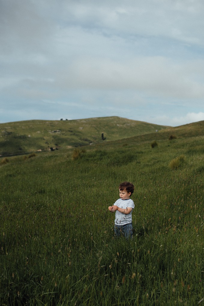 A young boy in a field on Christchurch's Port Hills