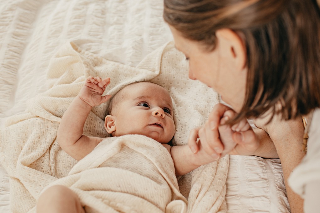 Mother smiles at newborn son in Christchurch, New Zealand