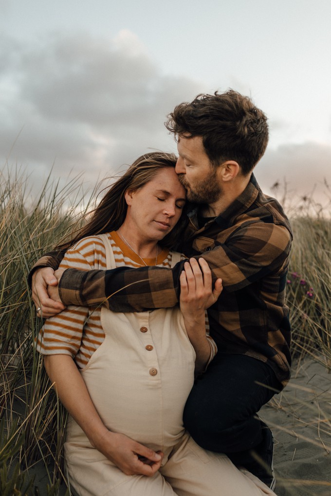 Couple on New Brighton beach maternity photos